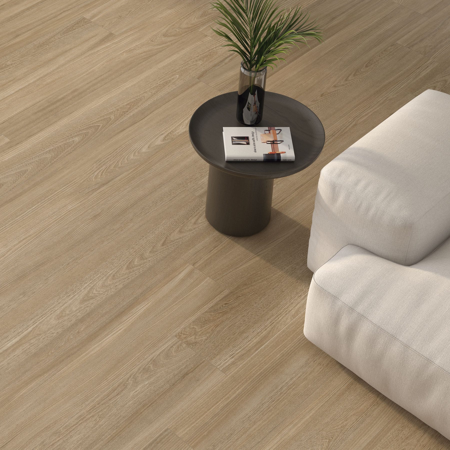 Detalle de suelo porcelánico efecto madera junto a un sofá blanco