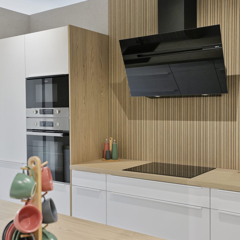 Cocina blanca y madera con campana negra angular y horno doble empotrado