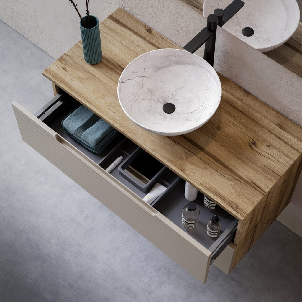 Mueble de baño de madera con cajón abierto y lavabo de piedra sobre encimera